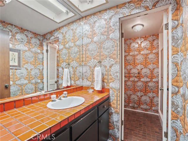 Down the hall from the entry way is this fun, retro, bathroom with shower. Down the hall from the entry way is this fun, retro, bathroom with shower.