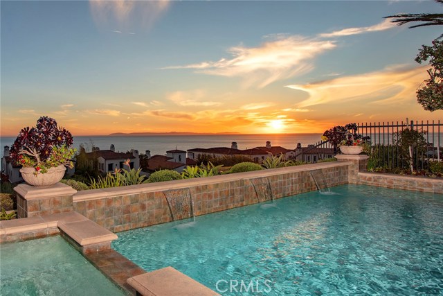 18 Rockshore Bluff Newport Coast, California RARE SINGLE LEVEL WITH VIEWS……..Nestled behind the gates of Newport Coast’s coveted private community, Crystal Cove, this extremely rare single level seaside estate represents value and craftsmanship around every corner with upgrades featured throughout. Located on a quiet cul-de-sac the 4-bedroom suite 4.5 bath home offers 180-degree coastal views with year-round sunsets and Catalina resting in the backdrop. The gracious master retreat offers a spa like bath, oversized walk in closet, and ocean facing French doors that lead you to a covered loggia with a fireplace. The fourth bedroom suite (which was a rare option on this model) has an attached office/bonus room, with two private external entrances. In addition to the finely appointed bedroom suites the property boasts Viking Clad chefs’ kitchen, formal and informal living spaces, formal dining room and resort like grounds. The exterior reflects the best southern California coastal living has to offer with pool and spa, water features, fireplace, Built in BBQ station, exquisite hardscapes, lush landscaping, and endless views.