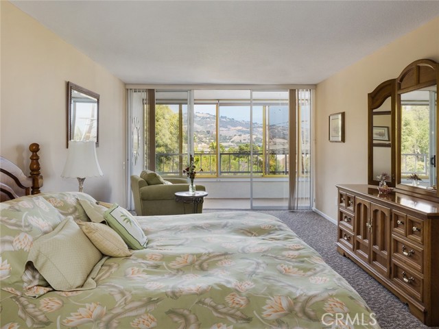 Another view of master bedroom with balcony visible.