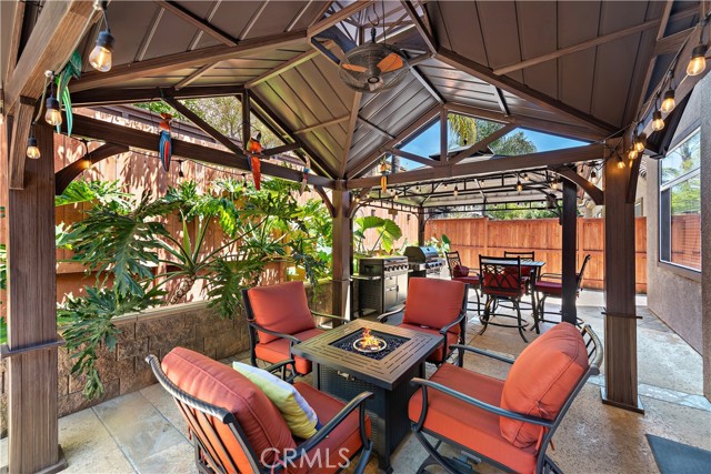 Welcome to your backyard tropical paradise boasting two quality gazebos (each with added lighting and a fan for air circulation). The two outdoor cooking appliances remain with the home too!