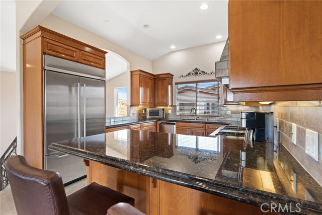 Stainless appliances, counter depth refrigerator, breakfast bar.