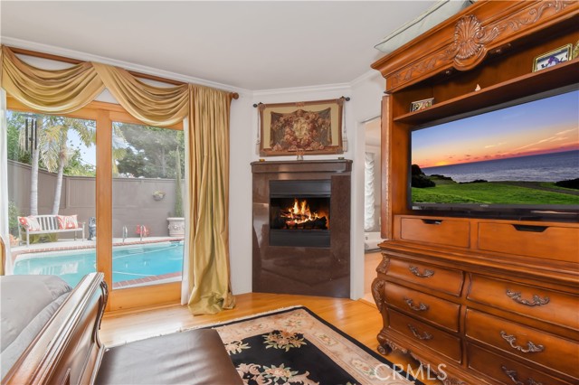 Primary bedroom gas fireplace with access to pool