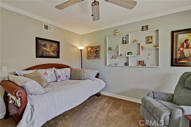 2nd bedroom offers ceiling fan and crown moldings