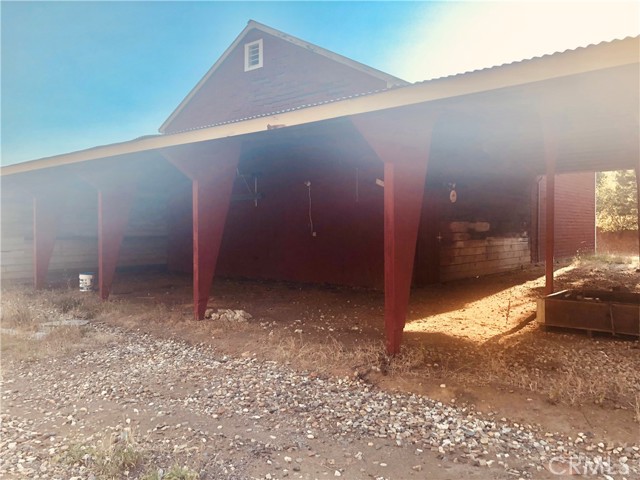 Covered Stalls/Carport Area that is behind Barn and another out building.