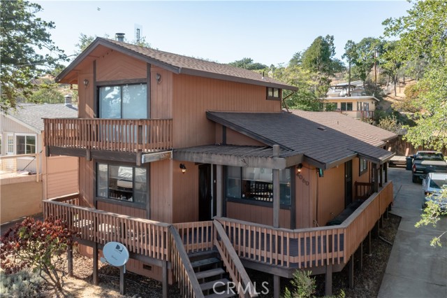 4060 Mesa Drive Clearlake, California Lake Views at Lily Cove! This turn-key 3 bed / 2 bath 1,666 SQFT home is located across the street from beautiful Clearlake and boasts stunning panoramic views of the lake & the mountains surrounding. The home has been updated to include newer carpet & interior paint throughout. The living room with a stately freestanding wood burning stove on a brick hearth & windows with newer motorized blinds. The Kitchen & dining nook have lovely lake views, newer laminate flooring, tiled countertops, built-in electric oven, microwave & cooktop + a newer dishwasher. The access door in the kitchen provides easy access to the wrap-around deck for outdoor dining or entertainment. 2 comfortably sized bedrooms and 1 bathroom are located on the main level. The 2nd level is dedicated entirely to the master suite with private deck access + views and ensuite master bath. The bathroom has been updated with a newer vinyl flooring, stall shower & light fixture. Enjoy the private paver patio in the backyard including a large storage shed. The oversized 2 car garage has laundry hook-ups, tons of storage cabinetry + sink. A water softening system and newer roof are an added bonus! Enjoy deeded beach right, lakefront access with boat launch and double piers in the Lily Cove members only lake access area. This home would make a wonderful retreat for a weekend getaway or permanent full time residence! Enjoy "Lake Life" at this beautiful Lily Cove home! |JPqauzSYpD8