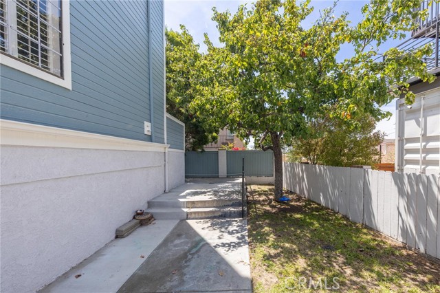 Side yard and entrance to corner unit.