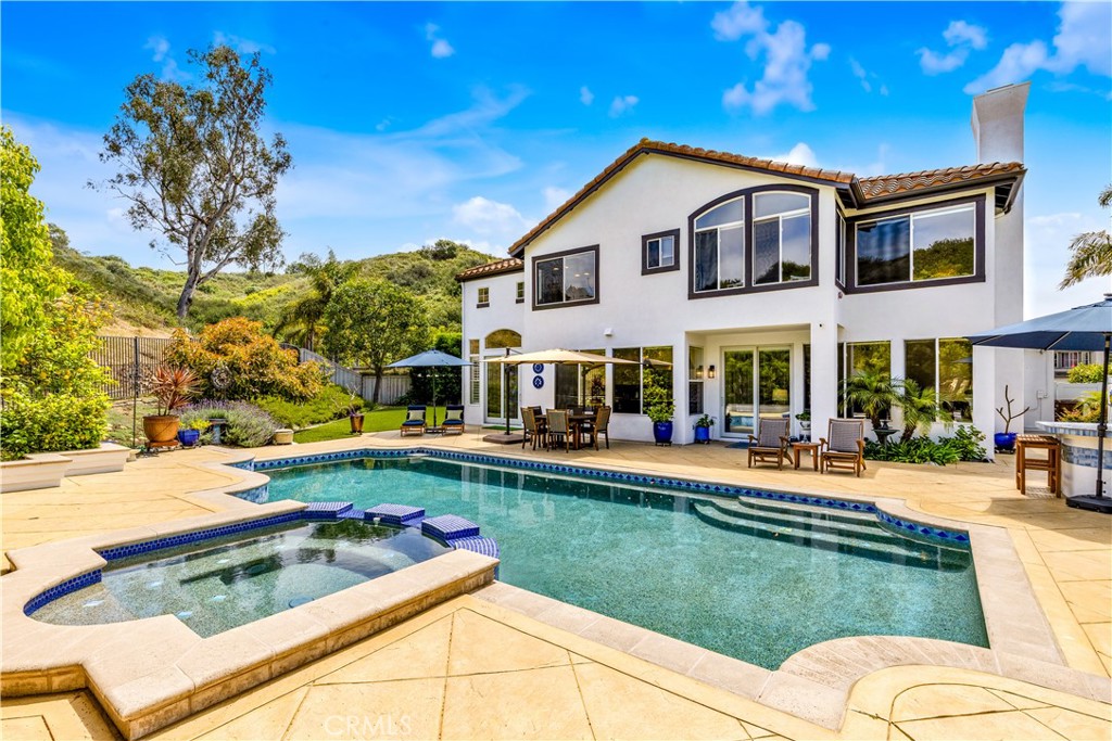 Welcome to 424 Bolivia - an exceptional home offering the largest floor plan & 1 of only 4 oversized lots of its kind in the ocean view community of Harbor View. This beautifully remodeled 5bed, 3bath home spans approximately 2,926 square feet & is set on an expansive pie-shaped lot with a prime cul-de-sac location. Step inside & discover a thoughtfully redesigned interior featuring polished travertine flooring throughout the main level & medium-finish walnut wood floors on the stairs & upper level. The formal living & dining rooms boast soaring two-story ceilings & are lined with walls of windows, flooding the home with natural light. A stunning, fully remodeled kitchen is the highlight of the main level with custom white shaker cabinetry finished with quartz counters, an enlarged center island with pendant lighting & breakfast bar, stainless steel appliances, & a completely customized pantry with dedicated broom & vacuum storage. A coveted main level bedroom features built-in desk & storage plus a walk-in closet. The main level bathroom has been updated with a stone countertop, new white cabinetry, travertine walk-in shower, & frameless glass enclosure. Upstairs, the primary suite stuns with vaulted ceilings & windows framing scenic hillside views. The spa-like en suite includes an oversized dual-sink vanity with slab granite counters, custom travertine surround at the soaking tub & walk-in shower, & walk-in closet. A hall bathroom for the uppder level bedrooms features a savvy split design with separate toilet/tub area & has been remodeled with stone counters, dual sinks, white finish cabinetry, & custom travertine surround at the tub/shower. The builder's 5th bedroom is currently configured as a loft & can easily become a bedroom, adding versatility to the living space. Your new backyard is the true hallmark of the home. Enjoy your own private paradise featuring an oversized pool & spa, a built-in BBQ/bar area, stained concrete patio, & a large turfed lawn for play & relaxation. The front yard is equally stunning with turf & custom hardscaping, & the entire exterior was recently repainted in a chic contemporary white with bold dark accents. So many more upgrades you just have to see! Enjoy close proximity to Lobo Elementary School, Rancho San Clemente Park, & the exclusive Life Time Fitness club plus just minutes from top-rated schools, shops, restaurants, world-class surf & beaches, & all things San Clemente ... your best lift starts here!