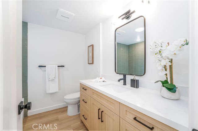  Guest bath with large vanity, soaking tub and shower with tile surround and solatube