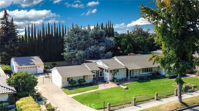 562 W 18th Street Upland, California Few homes offer such an expansive property size of almost 1/2 acre AND a next generation suite for families and friends. This incredible home offers a private-feeling backyard with mature, lush trees. The larger than normal covered patio offers shade for the blazing summer heat and a peaceful retreat to enjoy the pitter patter of the rain during winter. There are so many features throughout the home that are unique such as wood beam ceilings, an oversized, cozy fireplace, indoor laundry room and so much more! With the additional kitchen set up, extended family or friends can enjoy a private space in the home. Just see this home for yourself without leaving your own home, by immersing yourself in the 3D virtual tour and sliding through engaging photos. This home won't last long!
