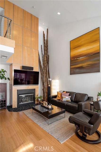 Custom gas fireplace with river rock hearth & contemporary paneling