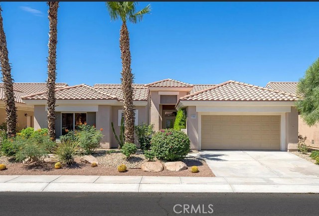 Beautiful desert curb appeal with mature palms, low-maintenance landscaping and a welcoming covered entry.
