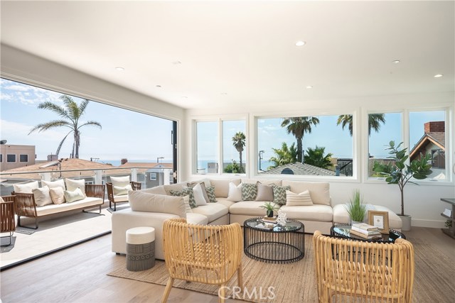 409 30th Street Manhattan Beach, California Gorgeous brand new beach plantation home with ocean views. This home is nestled perfectly on a corner lot in Manhattan Beach which provides a massive amount of natural light to all three floors. It is located just 3-blocks from the beach, close to north end shops, restaurants, Sand Dune Park, and Award-Winning Grandview Elementary School. Live the ultimate Manhattan Beach lifestyle in this unique home that offers many amazing features, with ocean views to enjoy the warm summer evenings on the large sunny deck with 8-foot tall La Cantina stacking bi-fold doors that open up, creating an indoor-outdoor feel on the entire top floor. All four bedrooms have their own bathrooms. There is a 3-stop elevator, hardwood floors throughout, and the home is air-conditioned. The bright and light gourmet kitchen has Thermador stainless steel appliances, breakfast nook, ocean-view bbq deck, walk-in pantry, beverage mini-fridge, porcelain slab countertops, including the center island.
