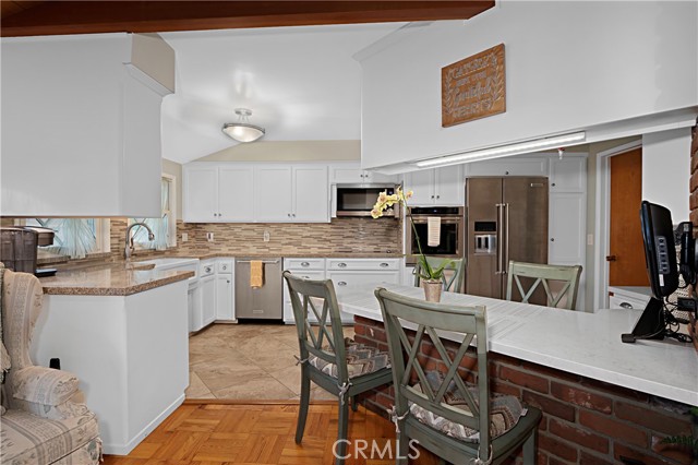 The kitchen has been tastefully updated with quartz counters, glass backsplash and updated cabinetry.