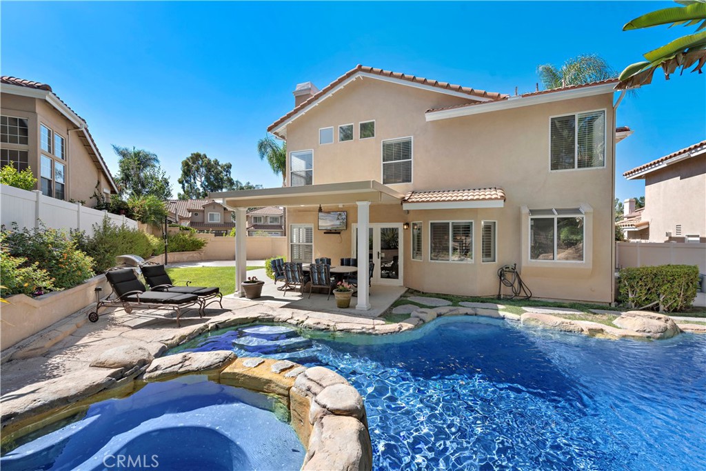 25866 Majorca Way Mission Viejo, California Tropical oasis pool home in highly sought after Bel Air tract of Calafia! This nicely appointed 4 bedroom home features travertine floors, plantation shutters, dramatic high ceilings in the living room, formal dining room, wine storage room, family room with cozy fireplace and upgraded kitchen with granite counters, center island, cherry wood cabinets, stainless steel appliances and breakfast dining nook area. The master bedroom is light and bright with vaulted ceilings, two walk-in closets and spacious bathroom with granite tile floors, dual sinks and separate walk-in shower and bathtub. The other 3 bedrooms have ceiling fans and share a bathroom offering dual sinks and shower/tub combo. This premium oversized lot is a dream come true with a gorgeous custom rock pool with spa and slide! There is a covered patio area perfect for dining al fresco and a huge side yard with grass and basketball half court! Located on a culdesac street and walking distance to award winning Bathgate Elementary + enjoy Lake Mission Viejo privileges including boating, fishing, 2 beaches and tons of events and activities. Low tax, no mello roos and safe friendly neighborhood makes this the perfect place to call home!