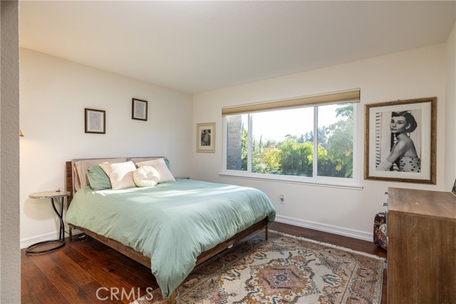 Upstairs bedroom suite offers tree-lined views of the backyard.