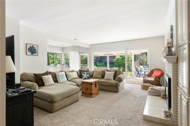 The family room looks out on the rear garden and pool