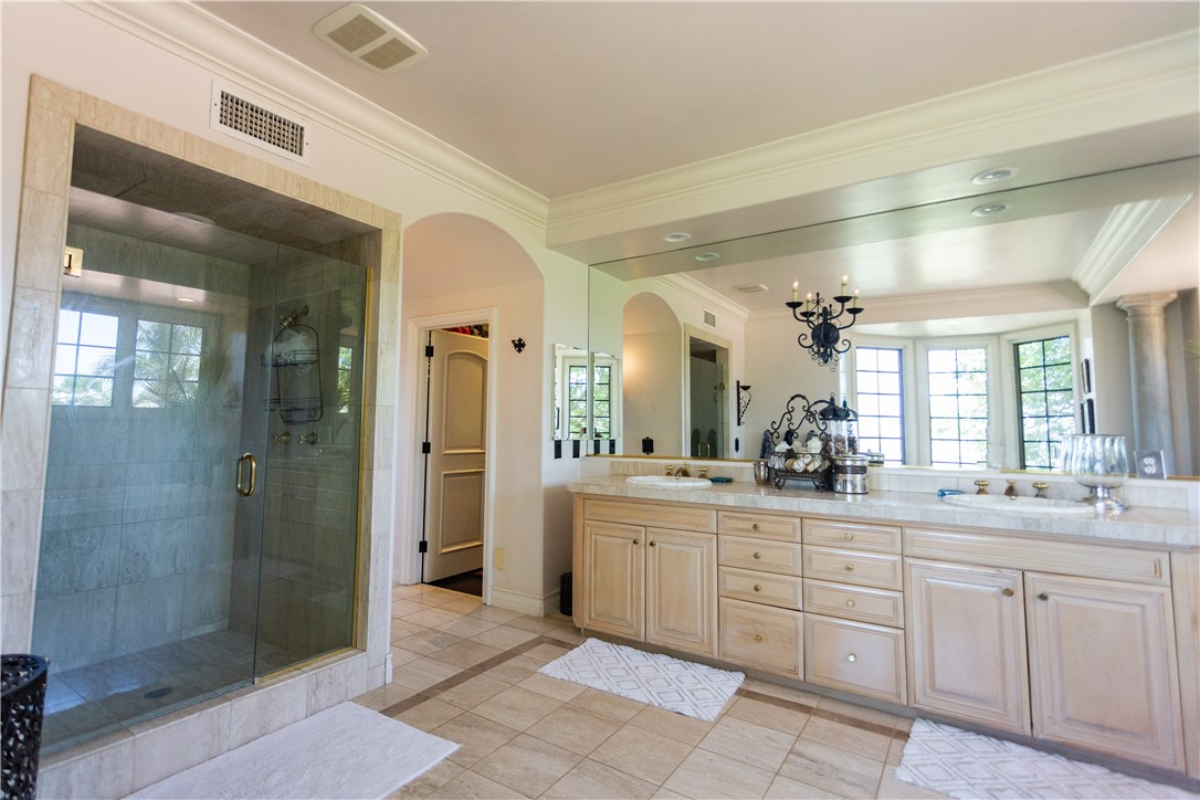 Master bath has dual sinks and a large walk-in shower. That door leads to the walk-in closet