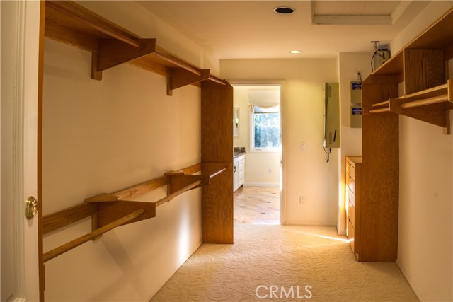 Massive walk in closet with access to bathroom and double door entrance to Master Suite