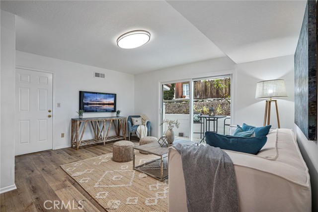 Downstairs den that opens to side sitting area.