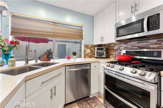 Blinds at window open from top or bottom. Kitchen was newly updated in the last three years with shaker cabinets and quartz counters, pendant lighting, recessed lighting, and backsplash. Appliances to remain. Just enough space to casually sit at the counter.