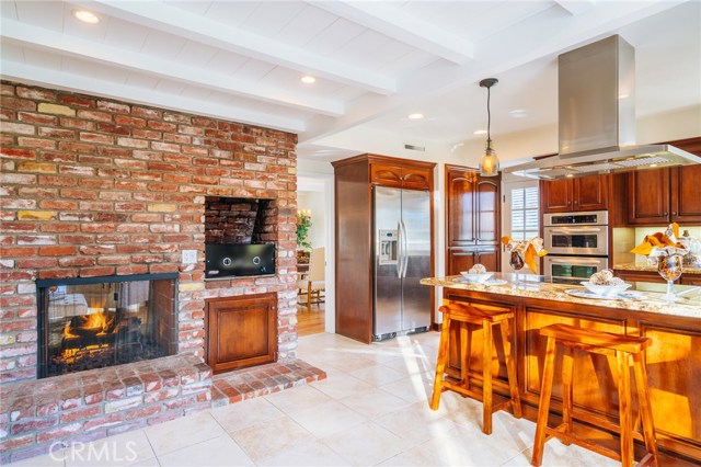 The fireplace is a focal point of the kitchen/family room space.