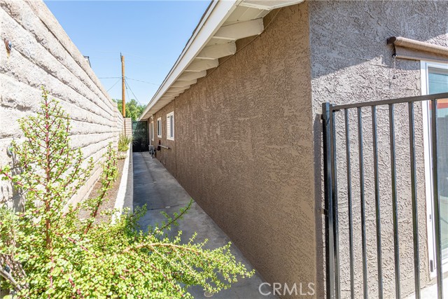 Gated side yard perfect for a dog run and/or storage!