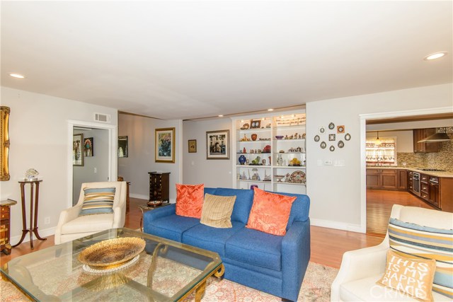 Living room with sparkling hardwood flooring and recessed lighting!