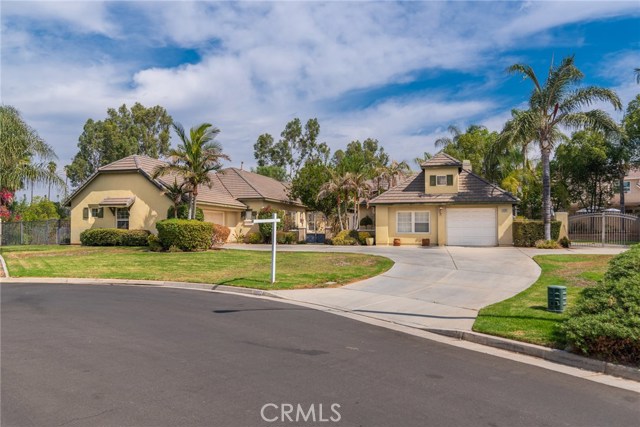 16082 Citrus Grove Court Riverside, California Beautifully upgraded single story home with 4 bedrooms, plus an office at the end of a cul de sac. Travertine tile floors grand entry. Granite counters, custom paint and window treatments. Master suite with sculpted carpets and jacuzzi tub. High ceilings with crown molding. Two fireplaces. Walk in pantry and a butlter's pantry. perfect for entertaining with a huge covered patio, BBQ and pool with a vanishing horizon to accentuate the view. RV parking. check out the matterport link to see interior and floor plan