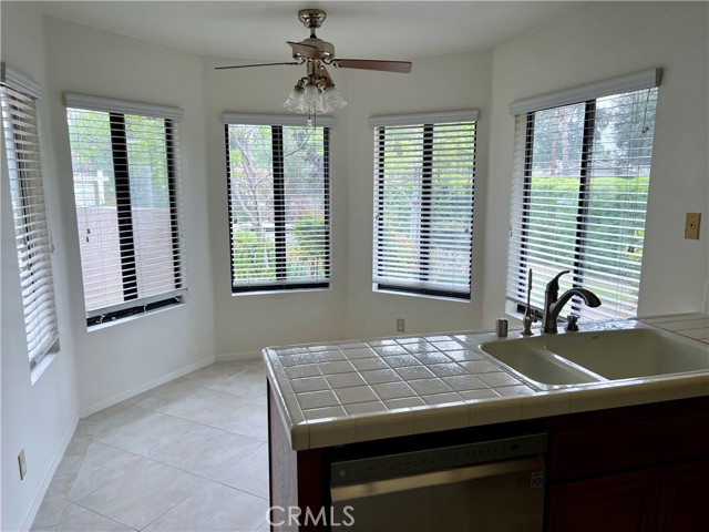 Kitchen open with dining nook, lots of windows look towards the front yard