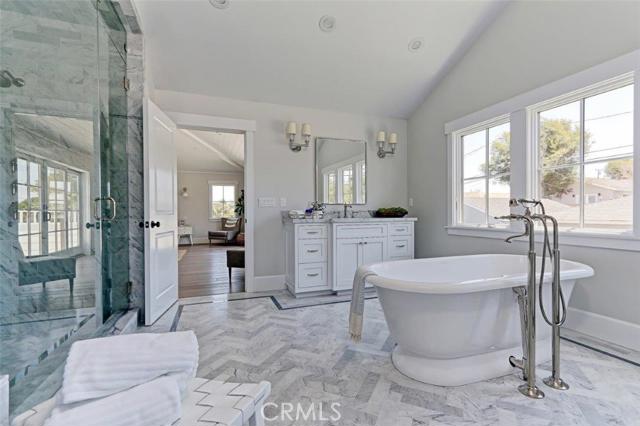 Luxurious master bath with herringbone marble tile