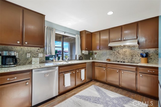 Kitchen has attached large balcony with peak-a-boo harbor views and snow capped mountain views at this time.