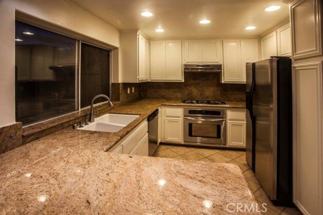 New kitchen in 2005 with tile floor, granite counters, refrigerator, newer lighting, breakfast bar