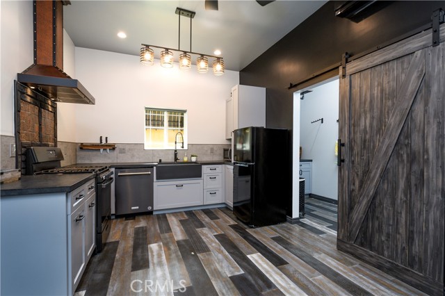 ADU Kitchen with Sliding Barn Door Open into Laundry Rm