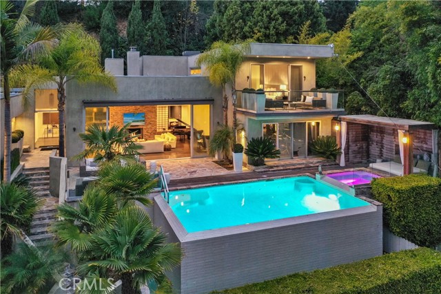 2731 Hutton Drive Beverly Hills, California Secluded Beverly Hills oasis, designed with privacy and contemporary architecture living harmoniously within nature. Beyond the secure front gate this estate sits atop a sprawling half acre lot, this incredible Beverly Hills property encompasses that of your own personal retreat with a rare mix of privacy and luxury. Floor to ceiling glass door entrance that fills the home with natural light.Main level features an expansive living room,vaulted ceilings, fireplace, and enormous sliding glass doors. Large infinity pool, hot tub, cabana and scenic views unlike any other in Beverly Hills.Impeccable guest suite and office area occupy one wing of the first floor.The chef's kitchen showcases a massive marble island, top end stainless steel appliances throughout and leads into a family room featuring a floor to ceiling fireplace and sliding glass doors that strike the perfect balance of indoor-outdoor living.Private massage room, fitness center and an in home music studio that has inspired some of the industry's biggest hits. Glass stairwell, showcasing outdoor bamboo trees and leads you up to the master suite that comprises the entire second floor.Master features immaculate wood flooring,high ceilings,private deck, and a master closet that would make James Bond green with envy.The ensuite master bathroom is adorned with a gorgeous,reclaimed wood finishes, a rainforest like master shower and floor to ceiling corner windows that showcase all of nature. Welcome to 2731 Hutton Drive.