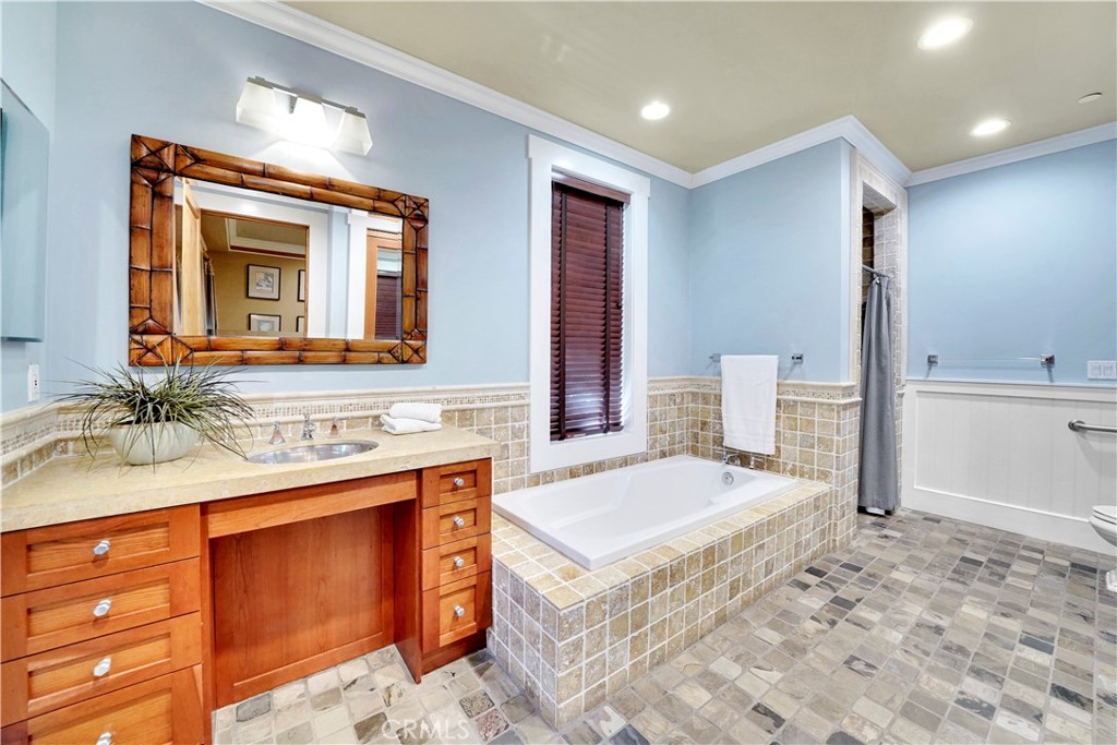 main floor bedroom bath with shower and tub