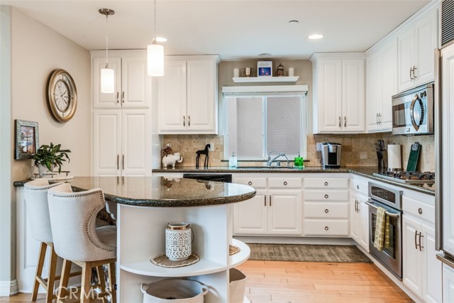 Kitchen with stainless appliances, granite counters and gleaming cabinetry