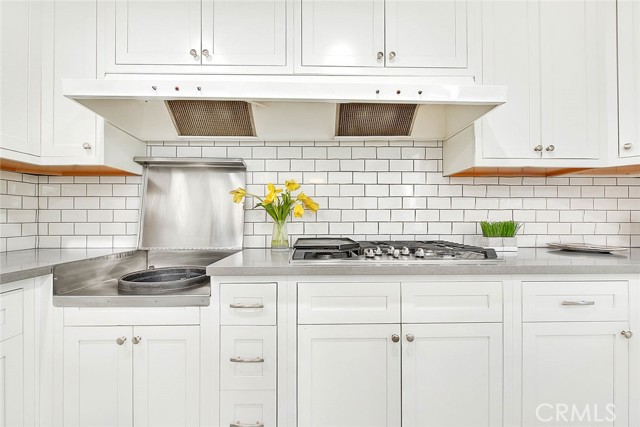 730: Remodeled Chef's Kitchen includes a wok stove for a deep bowl-shaped frying pan, 6-burner gas cooktop and dual exhaust fans.