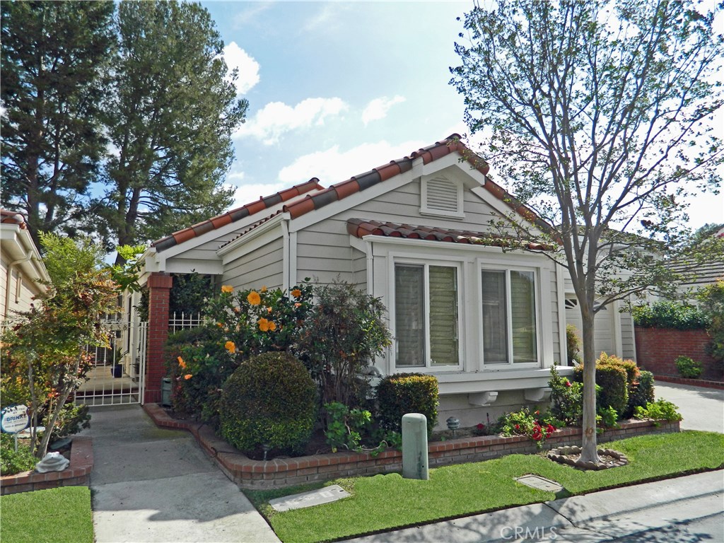 Enjoy beautiful Casta Del Sol in the newer, freshly painted, single level home, nestled in a quiet cul de sac. The popular floor plan features a spacious kitchen with breakfast bar and separate eating area, a formal dining room, a large living room with a vaulted ceiling and romantic brick fireplace, a large master suite with walk-in closet and tub and shower, plus patio access! The large secondary bedroom is perfect for office, game room, or guest room with a convenient adjacent bath. A pretty atrium enhances the entry, with wood/laminate floors and neutral carpet throughout. The large, two car, direct access garage has roll up doors. The private, covered patio is surrounded by greenbelt. Enjoy all of the amenities of this beautiful community, including pools, tennis, golf, garden area, gym, and various clubs and activities, including beautiful lake Mission Viejo!