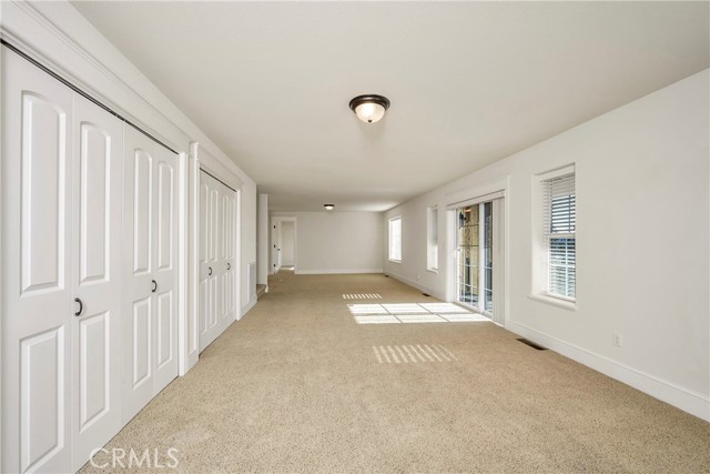 3rd Level - Family Room offers Deck access and lots of closet storage.