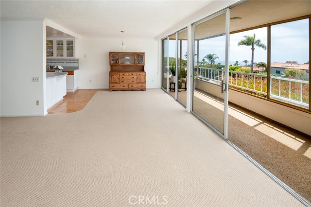 Ample dining area adjacent to porch with sunset view.