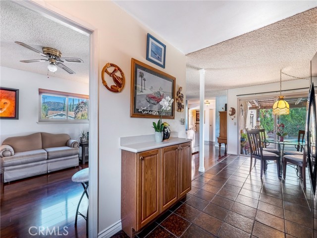 Kitchen enjoys the views into the den and the dining room with the sparkling pool in the background.