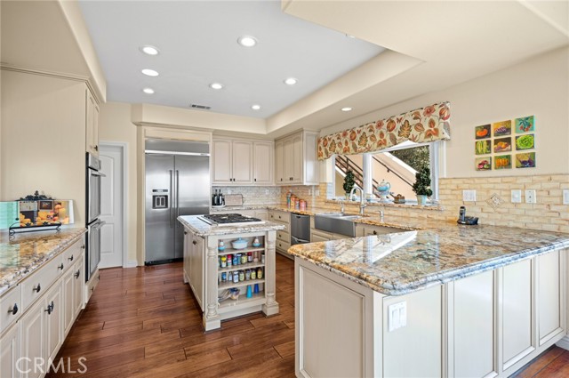 This area flows effortlessly to a reimagined kitchen where mealtime and social time are easily enjoyed by all.