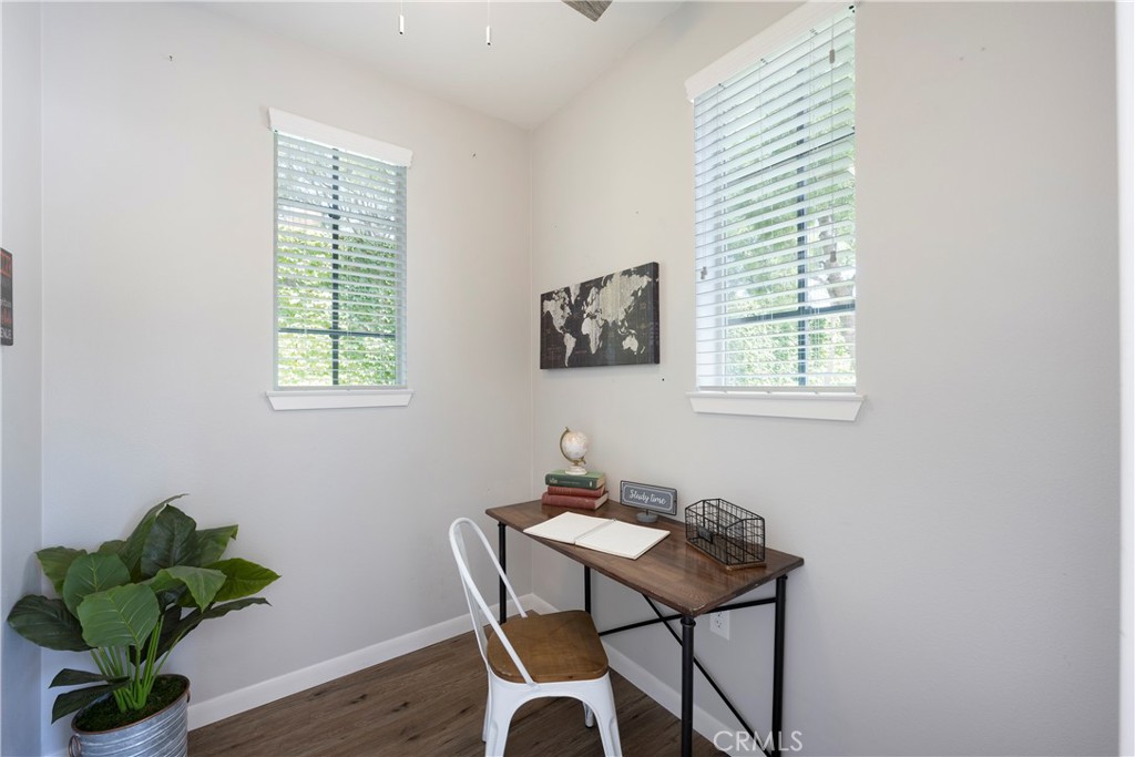 There is an Office Space located off the Garage with Dual Paned Windows, Ceiling Fan, and Neutral Toned Flooring and Paint!