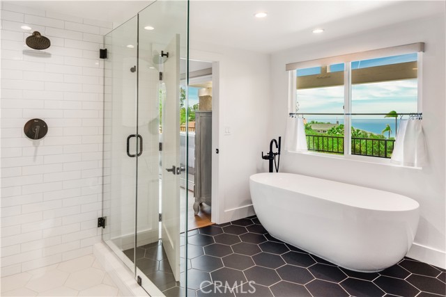Resort-like Primary Bath has soaking tub, separate shower & ocean views