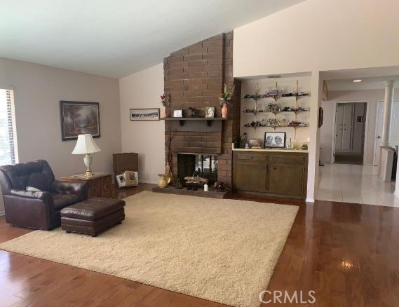 Family room with fireplace and wet bar, gorgeous wood floor w carpet inset