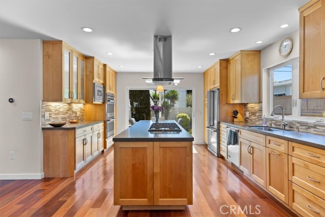 Kitchen has Brazilian Teak flooring, Viking appliances, and open concept living area.