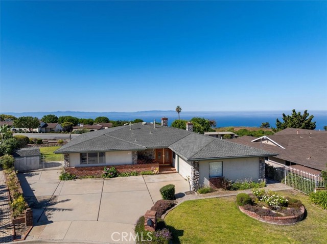 Front of house - drone shot, with ocean and Catalina views in the background.