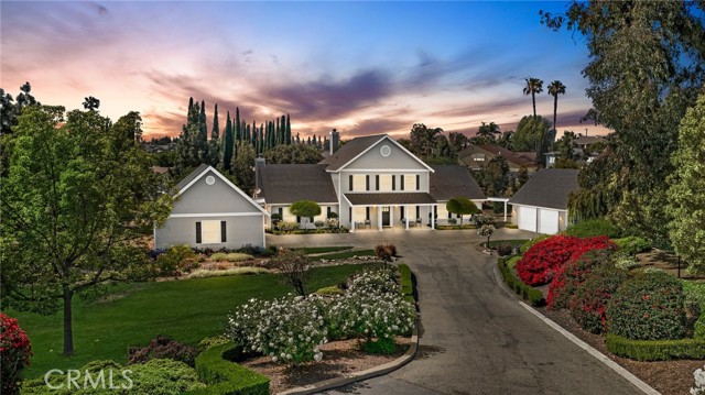 THIS HOME IS A MUST SEE!! SPECTACULAR Custom-built home in Yorba Linda on a HUGE lot of 62,553 Square Feet, 1.44 acres and has been zoned for Horses! This home features an open and bright floorplan with DOWNSTAIRS MASTER SUITE that includes a large walk-in closet with closet organizers and en-suite contains a beautiful two sink vanity, clawfoot tub and beautiful brick flooring. The Gourmet kitchen features large kitchen island, granite countertops, 6 burner range, TWO pantries, beautiful cabinetry, stainless steel appliance and is adjacent to the dining room which features a beautiful fireplace with custom mantle. HUGE family room with cozy pot belly stove fireplace with custom mantle-perfect for entertaining. This home also includes a bonus room and office. Upstairs includes 2-bedroom suites that include their own walk-in closet and full bathroom. Not to mention that in the closet is direct access to TWO Attic spaces. These attic spaces provide so much potential for additional square footage once finished out! Each bathroom also contains clawfoot tub/shower combo. This home also features TWO garages that are 24 deep x 27 wide and garage doors are oversized for larger trucks/SUV. Workshop in the garage has 100 amp panel and half bath. It can easily be converted into a mother-in law suite. This home has also been freshly painted, NEW carpet, NEW Water Heater, NEW landscaping, and plumbing that has been re-piped. This private backyard is SPECTACULAR!!! The backyard features a covered patio with stone pavers, and it overlooks the manicured backyard with beautiful mature landscaping and fountain. OUTSIDE of manicured backyard is more land with many tree varieties that will give you plenty of room to stretch out and expand. NO MELLO ROOS OR HOA. This home includes a shared driveway with gated access. Conveniently located close to the Yorba Town Center, New Yorba Linda Library, restaurants, shopping, entertainment and close to the 91 Freeway and is located in the Placentia Yorba Linda School District Come view this beautiful home and make it yours today.