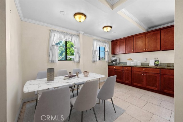 Eating area located in the kitchen. Surrounded by beautiful cabinets and granite countertops.