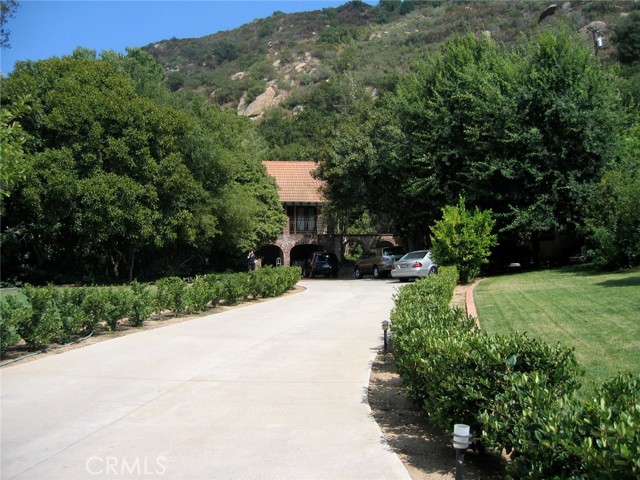 THE TUSCAN VILLA ESTATE: An idyllic country compound close to LA, Topanga Canyon, and Malibu Beaches. A perfect retreat for healthy peaceful & secure living. Set in nature with a magnificent mountain backdrop and rose gardens, this gated compound offering multiple permitted structures for expansive living set on 2.6 acres with over 7,000 square footage of spacious living, work, exercise, creative, and healing spaces: 1) Beautiful Tuscan Villa with bright spacious rooms, a chef's kitchen, elegant library, romantic master, and a grotto spa featuring an indoor swimming pool, steam shower, in ground jacuzzi, a sauna, and deck with a hot tub. 2) The magnificent glass gazebo offers the perfect space for your office or zoom room or gym 3) An amazing workshop space with plumbing and its own bathroom. 4) A separate 2-bedroom casita with a beautiful own kitchen, a private bathroom 5) Lots of storage buildings which could also be made into great studios Parking for many, many cars. Hiking trails nearby for walks and horse trails for riding Majestic grounds and fountains can also be an oasis for deep solitude and healing. Only 20 minutes to Hollywood, Burbank, 30 minutes from Malibu, Santa Monica. Easy access to the 118, 5 & 405 Square footages measured by a permit expediter. Buyers to rely entirely on their own independent verification of all information provided herein including zoning, square footage, etc. The agent is related to the seller.